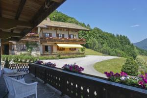 a house with a balcony and a driveway at Obersteinberg-Hof in Ruhpolding