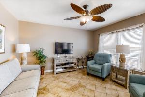 a living room with a couch and a tv at Islander Condominiums III in Fort Walton Beach