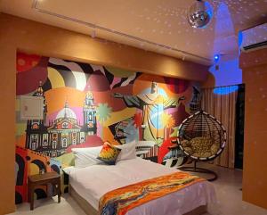 a bedroom with a bed with a mural on the wall at Time Light Walk B&B in Hualien City