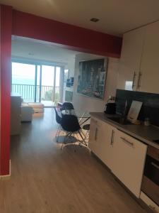a kitchen with a counter and chairs in a room at Exclusivo Apartamento Spa privado frente el mar in Miami Platja