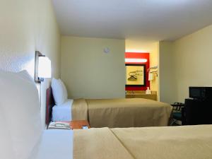 a hotel room with two beds and a mirror at Suite 16 Motel in Gore