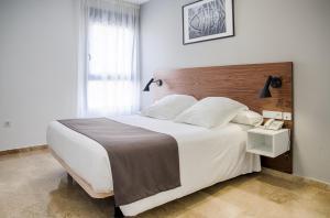 Postel nebo postele na pokoji v ubytování Plaza Alaquas