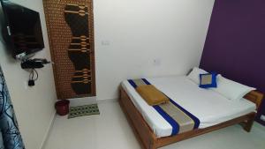 Postel nebo postele na pokoji v ubytování Green Apple Resorts