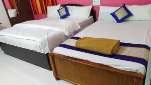 Postel nebo postele na pokoji v ubytování Green Apple Resorts