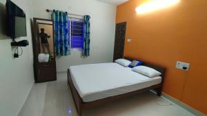 Postel nebo postele na pokoji v ubytování Green Apple Resorts