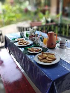 a blue table with plates of food on it at Cabins yafeth osa drake bay in Drake
