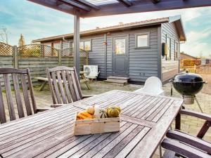 a wooden table with a box of fruit on a patio at 4 person holiday home in Svendborg in Svendborg