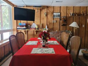 a dining room with a table with a red table cloth at Bowering Lodge in Blue Mountains
