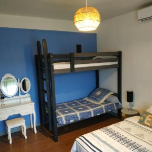 a bedroom with two bunk beds and a desk at Gîte de Sapiac in Montauban