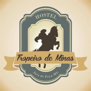 a vector illustration of a crest with a houstonisco de minas logo at Hostel Tropeiro de Minas in Juiz de Fora