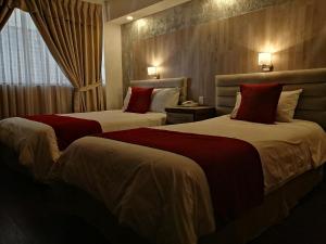 Postel nebo postele na pokoji v ubytování Hotel Chimborazo Internacional