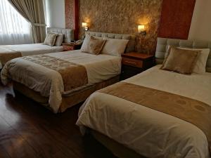 Postel nebo postele na pokoji v ubytování Hotel Chimborazo Internacional