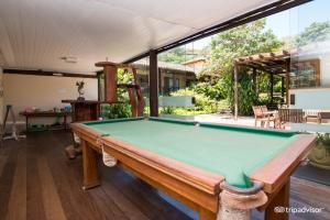 a pool table in the middle of a living room at Hotel La Forêt & Beach Lounge in Búzios
