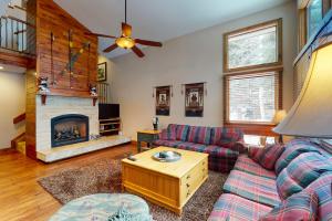 a living room with a couch and a fireplace at Courtside 23 - Spacious East Vail Townhome in Vail