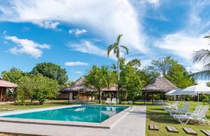 a pool at the resort with chairs and umbrellas at WAKAYA ECOLODGE in Pucallpa