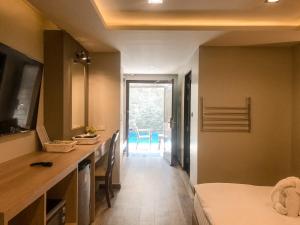 Postel nebo postele na pokoji v ubytování Hotel De Sripoom