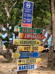 a bunch of signs in front of a beach at Mar azul 401 in San Felipe de Puerto Plata