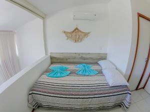 a bed in a room with two pillows on it at Flats Nannai Residence Vilas in Porto De Galinhas