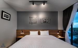 a bedroom with a bed with a camera on the wall at R2 Hotel in Nakhon Phanom