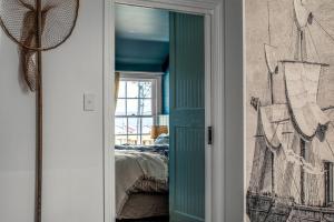 a bedroom with a bed and a window at Ship Inn Stanley in Stanley