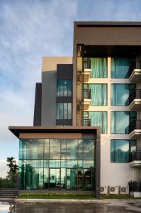 a large building with large glass windows at R2 Hotel in Nakhon Phanom