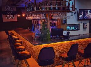 a bar with a bunch of bar stools at Hotel Wilson Santa Cruz in Santa Cruz