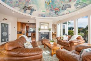 a living room with leather couches and a ceiling at Oceanview Miramar Home Steps to Beach Restaurants Trails Activities in Half Moon Bay