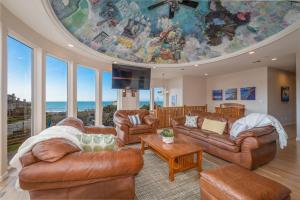a living room with leather furniture and a large ceiling at Oceanview Miramar Home Steps to Beach Restaurants Trails Activities in Half Moon Bay