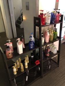 a shelf filled with lots of bottles of detergents at Hotel Patio in Hiroshima