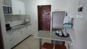 a small kitchen with a counter and a refrigerator at St Lucia Eco Lodge in St Lucia