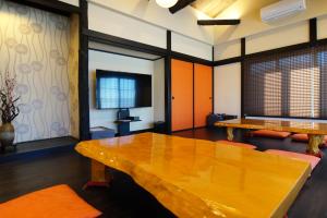 a conference room with a wooden table and ping pong tables at Luana Marue in Ito +36 photos
