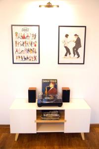 a white coffee table in a room with two pictures on the wall at Kashtan guest house in Kyiv