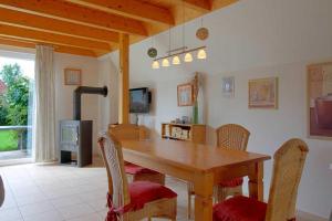 a dining room with a wooden table and chairs at SR Nordertill 7 in Dorum Neufeld