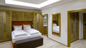 sypialnia z dużym łóżkiem i lustrem w obiekcie Hotel Diamond Country Club w mieście Atzenbrugg