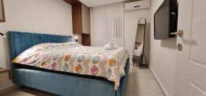 a bedroom with a bed with a stuffed animal on it at sea side eilat holiday apartment in Eilat +35 photos