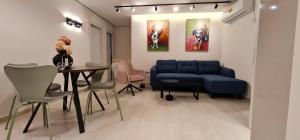 a living room with a blue couch and a table at Yuval holidey aprtment eilat in Eilat