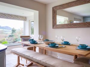 a dining room with a table and a mirror at Scarsdale in Kendal