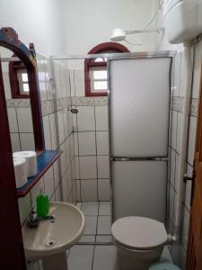 a small bathroom with a toilet and a sink at Pouso Jequitibá in Tiradentes +16 photos