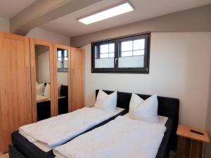 a bedroom with two beds and a window at Speicher Residenz Barth E3 App 1 in Barth