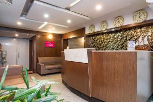 a waiting room with clocks on the wall at Nexstay Crystal Residency in Kozhikode