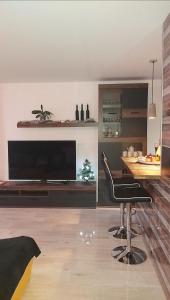 a living room with a table and a flat screen tv at Apartmán NAVRCHU in Brezno