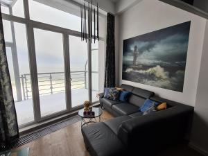 a living room with a couch and a large window at The Baltic Horizon in Dziwnówek