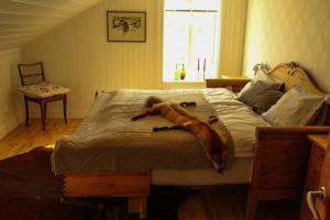 a monkey laying on a bed in a bedroom at Gammal Stugan SKOGSFEEN in Ytterhogdal