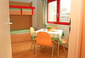 a dining room with a table and chairs and a bunk bed at ZirkelsteinResort gGmbH in Schöna