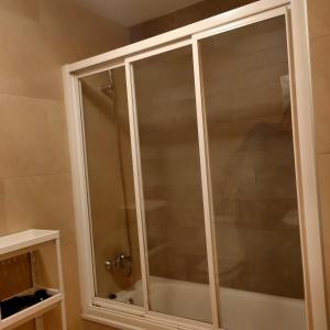 een glazen douchedeur in de badkamer bij Apartamento en el centro in Reus