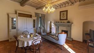 a dining room with a table and a fireplace at La Torre di Testa Lepre in Greve in Chianti