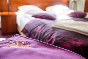 a purple blanket laying on a bed in a room at Hotel Barka in Kalwaria Zebrzydowska