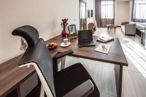 a living room with a table with a laptop on it at Glam Hotel Nairobi - Near Westgate Mall, Westlands in Nairobi