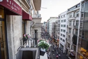 a view of a city street from a balcony with flowers at Bonne Sante Hotel in Istanbul