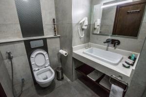 a bathroom with a toilet and a sink at Glam Hotel Nairobi - Near Westgate Mall, Westlands in Nairobi